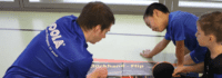 Zwei Jungen besprechen Technik mit Trainer