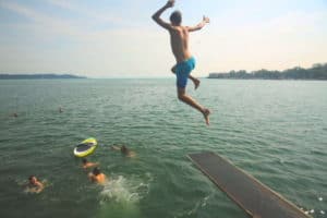 Junge springt in den See im Englisch Camp am Ammersee