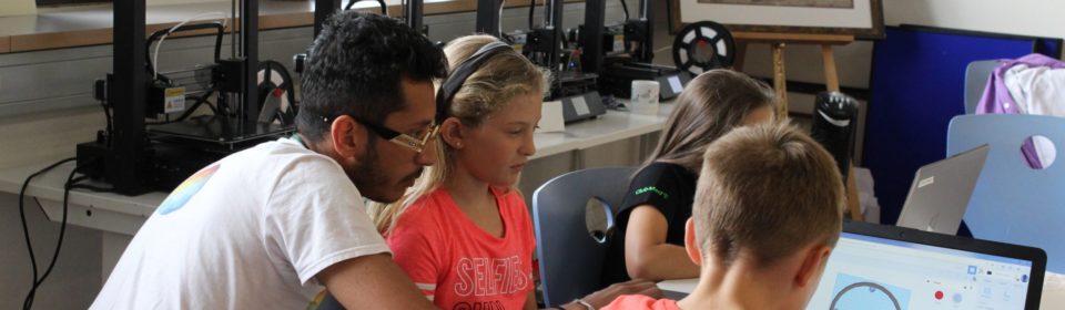 Teamer und Kinder vorm Computer