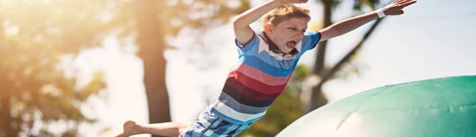 Junge springt auf riesige Bälle