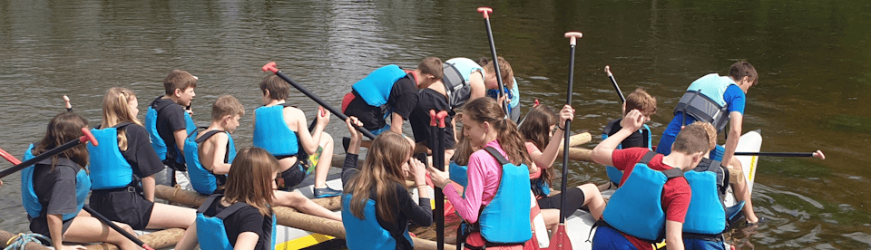 Kinder in Schwimmwesten am Ufer