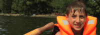 Junge sitzt auf Ruderboot