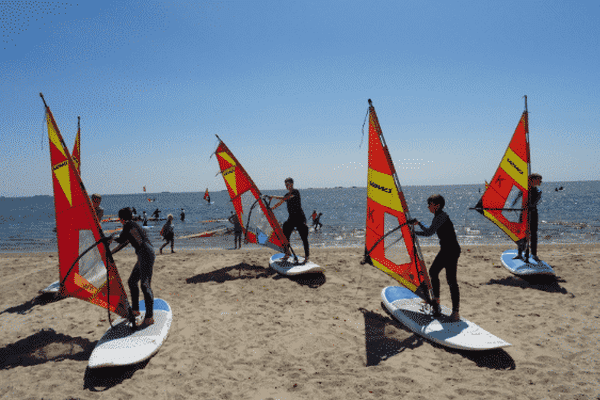 Kindergruppe auf Sufboards an Land im Englisch und Surf Camp Föhr